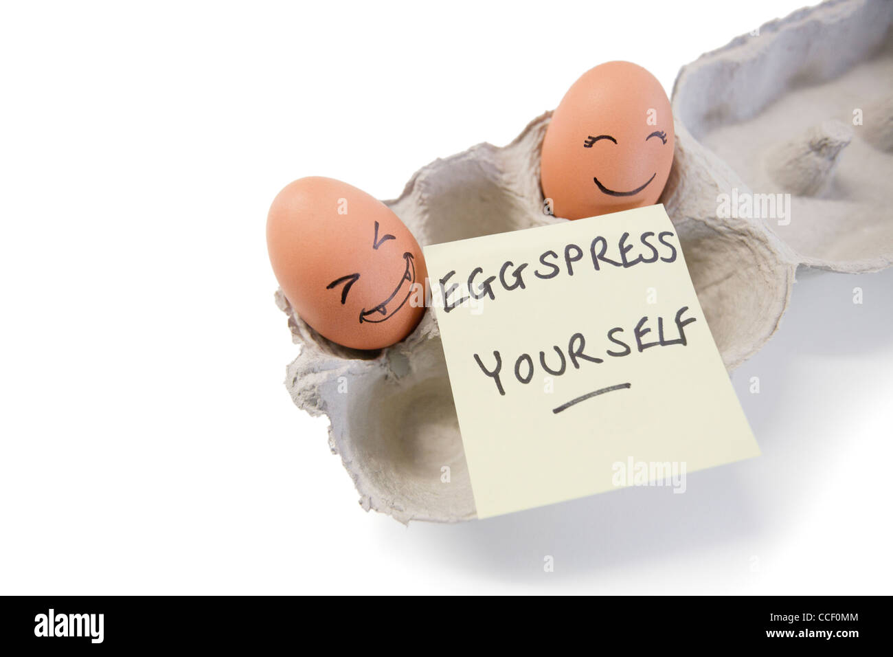 Two eggs with a 'eggspress yourself' note Stock Photo