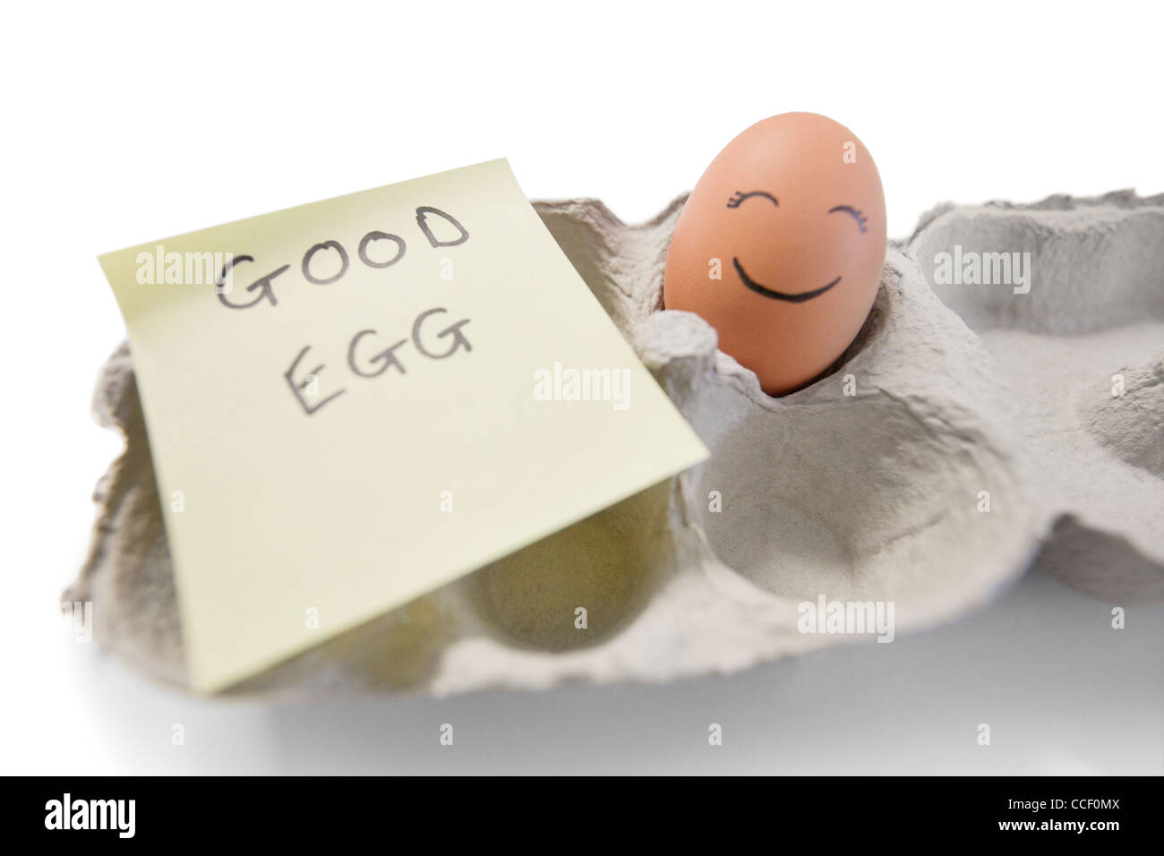 Happy egg with a note written 'good egg' Stock Photo