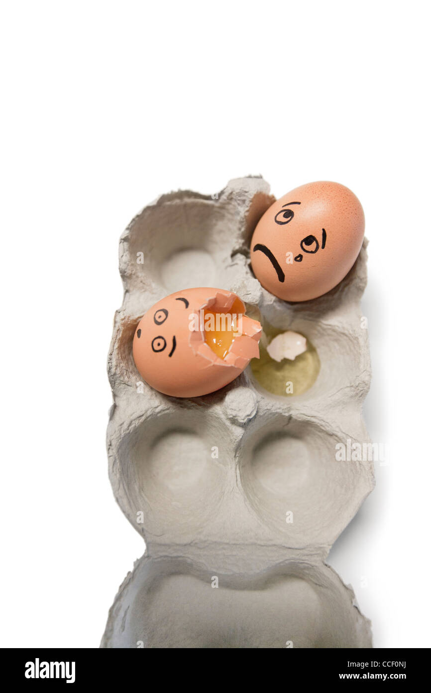 Eggs in a carton with one egg broken Stock Photo