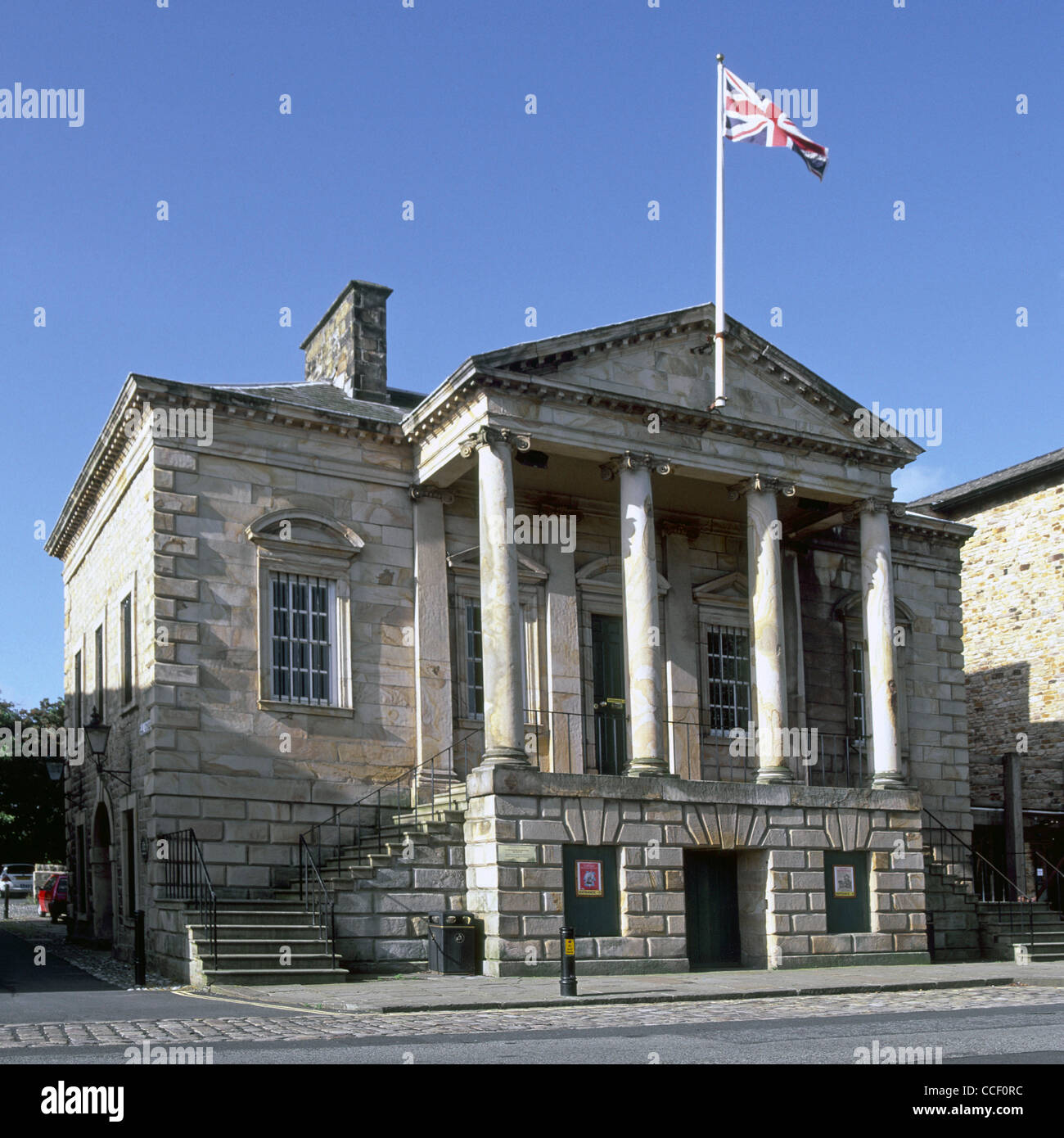 Colonnade at front of Maritime family museum in former Custom House building with Union Jack flag River Lune quayside Lancaster Lancashire England UK Stock Photo