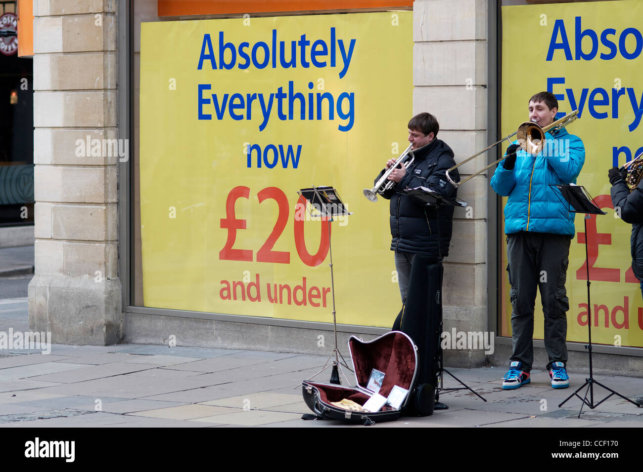 Liquidation Sale with Buskers outside shop Stock Photo