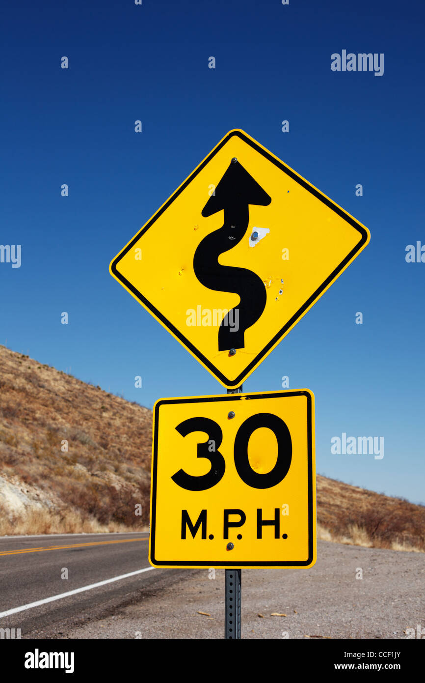 A highway sign indicating curves ahead. Stock Photo