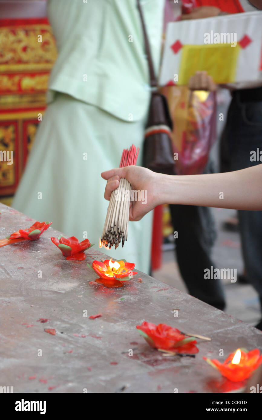 People Light Incense Sticks From Candle Before Offering Prayers At A Chinese Temple Chinese New Year Festival 2012 In Bangkok Stock Photo Alamy
