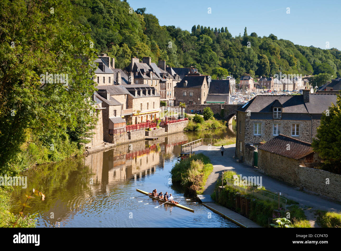 A four place skuller in the foreground of this image from Dinan, Brittany, France. The medieval port is one of the best preserve Stock Photo