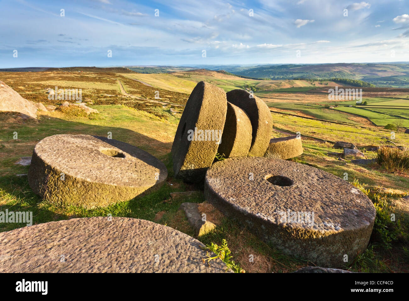 Millstones on Stanage Edge in the Peak District National Park. with the Hope Valley in the distance Stock Photo