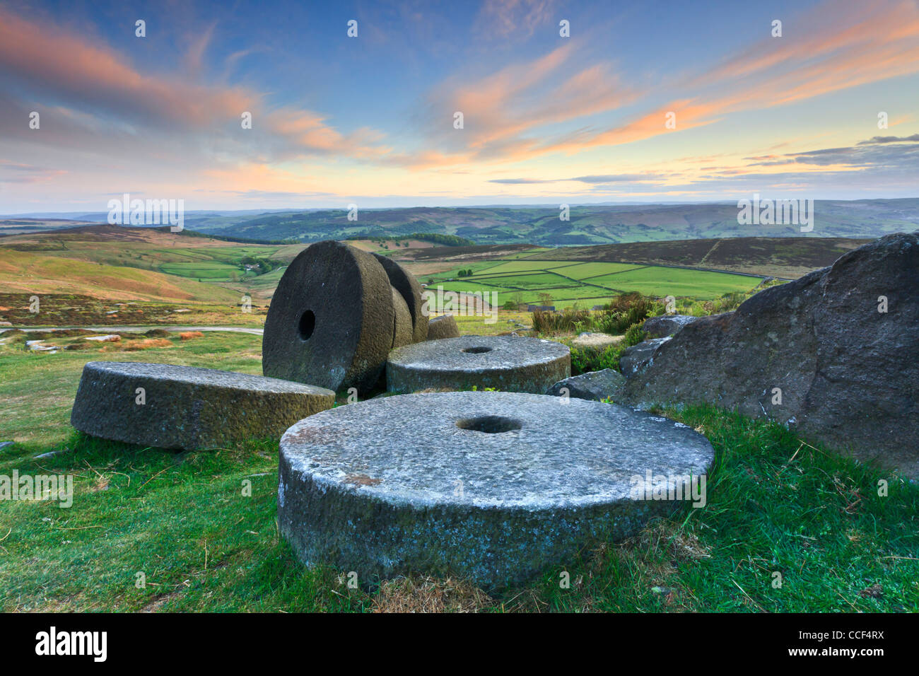 Millstones on Stanage Edge in the Peak District National Park.  Captured at sunset with the Hope Valley in the distance Stock Photo