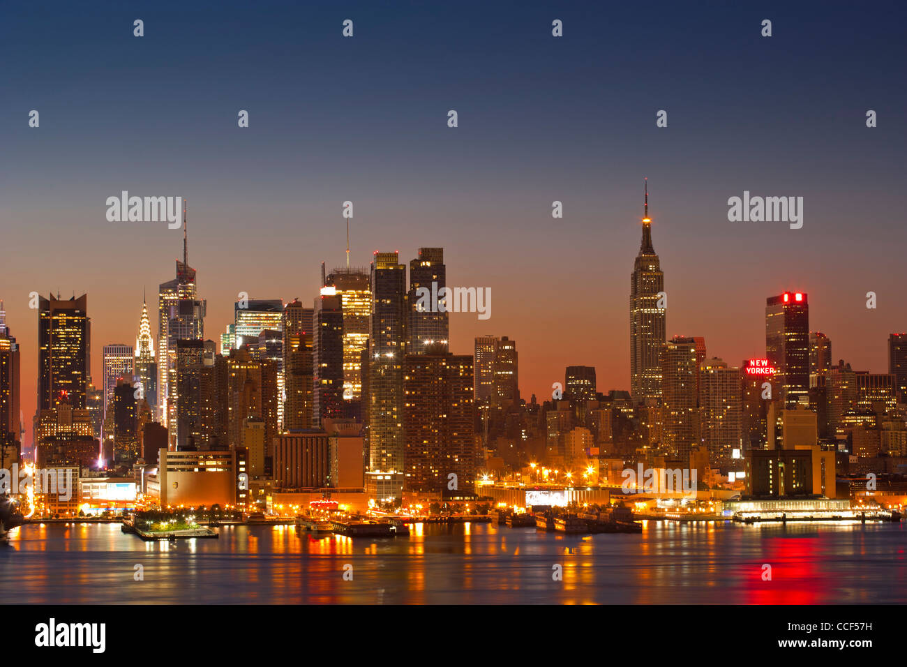 The Sun rises behind Midtown Manhattan Skyline Stock Photo