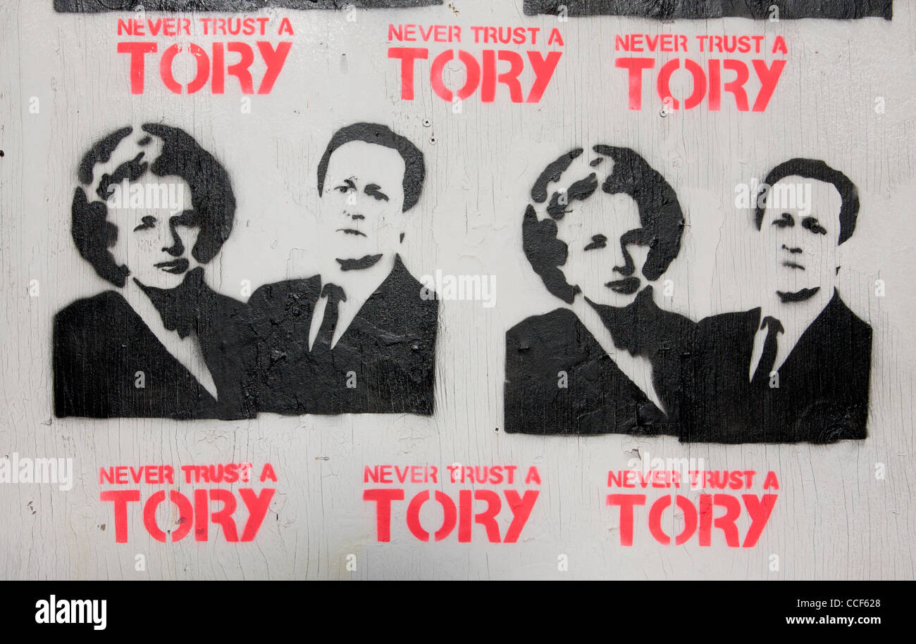 'Never Trust a Tory' stencil poster art with Prime Ministers Thatcher and Cameron on boarded-up derelict pub Cardiff Wales UK Stock Photo