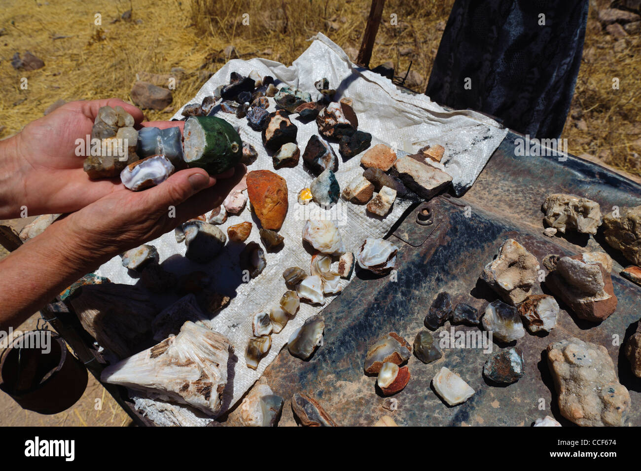 Handful of gemstones  shown at a gemstone stall along the road in Damaraland, Namibia. Stock Photo