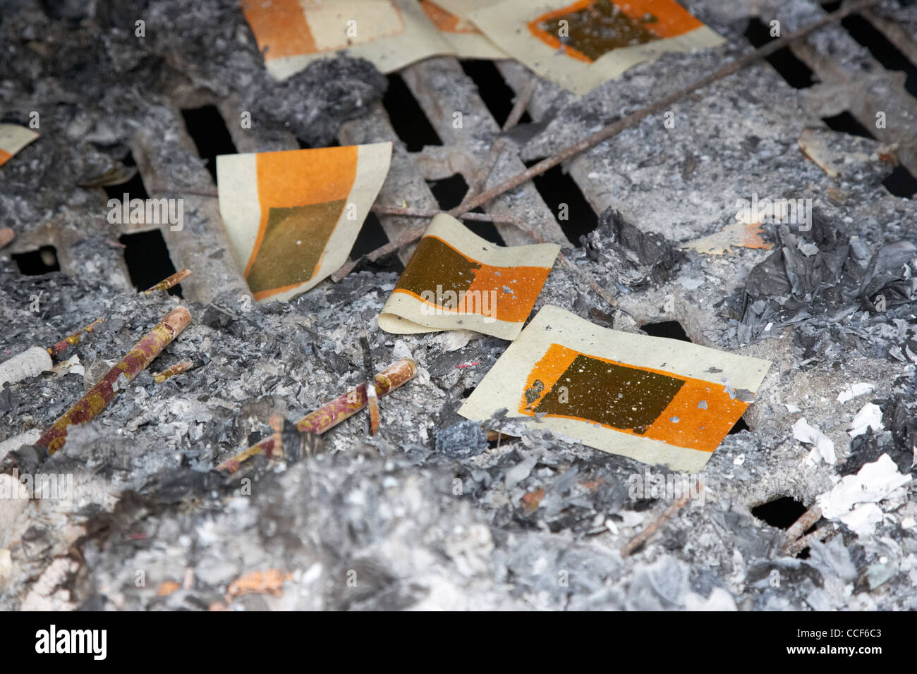 burnt remains of joss paper offerings in the furnace in a monastery sha