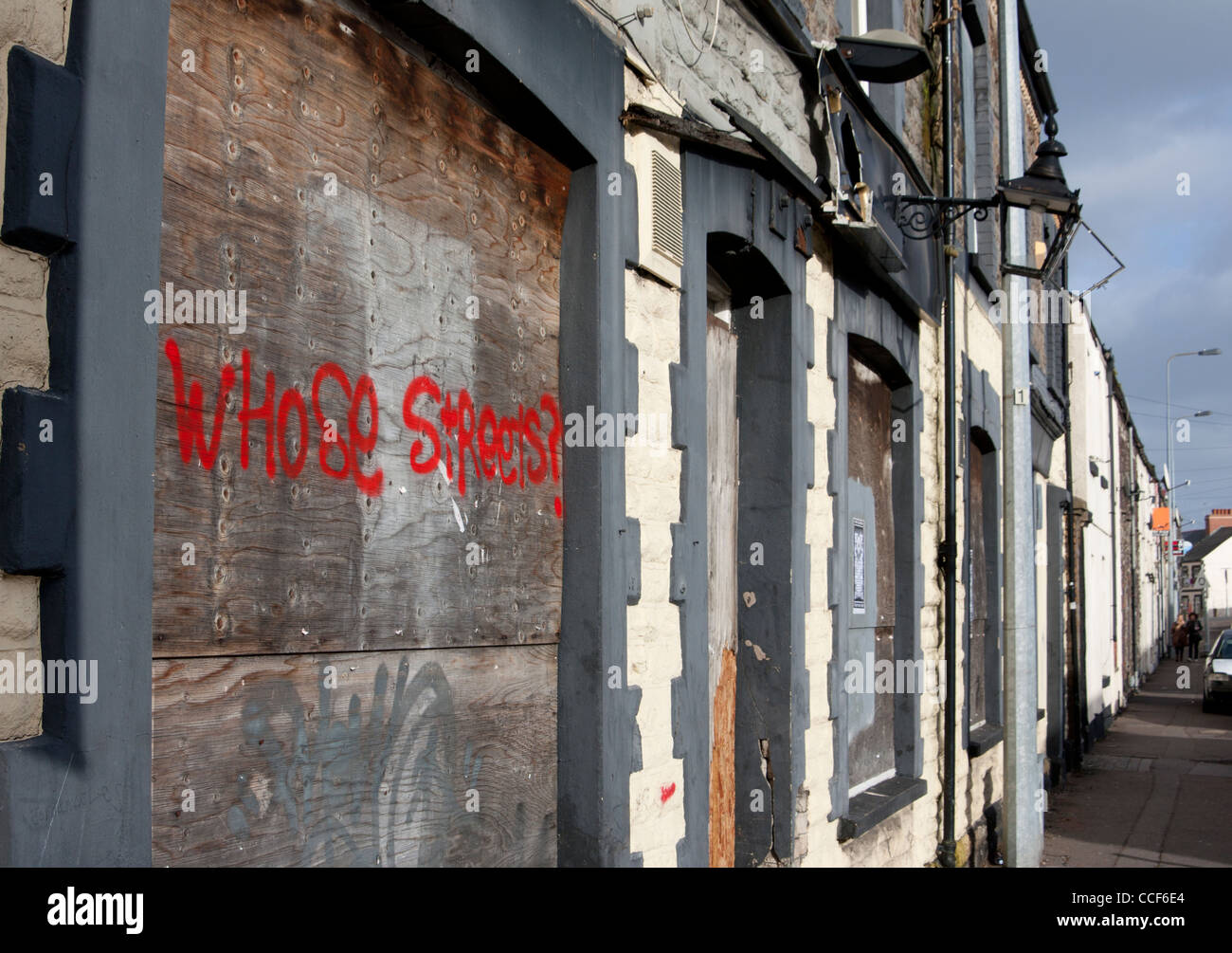 'Whose Streets?' graffiti on boarded up building Cardiff South Wales UK Stock Photo