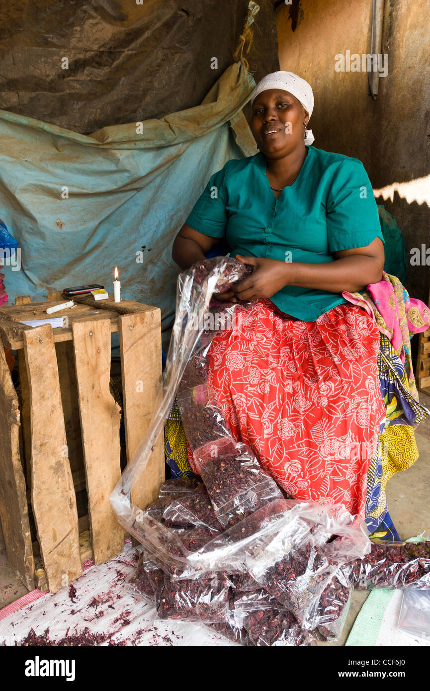 A woman packs and seals herbs in plastic bags in Moshi Kilimanjaro Region Tanzania Stock Photo