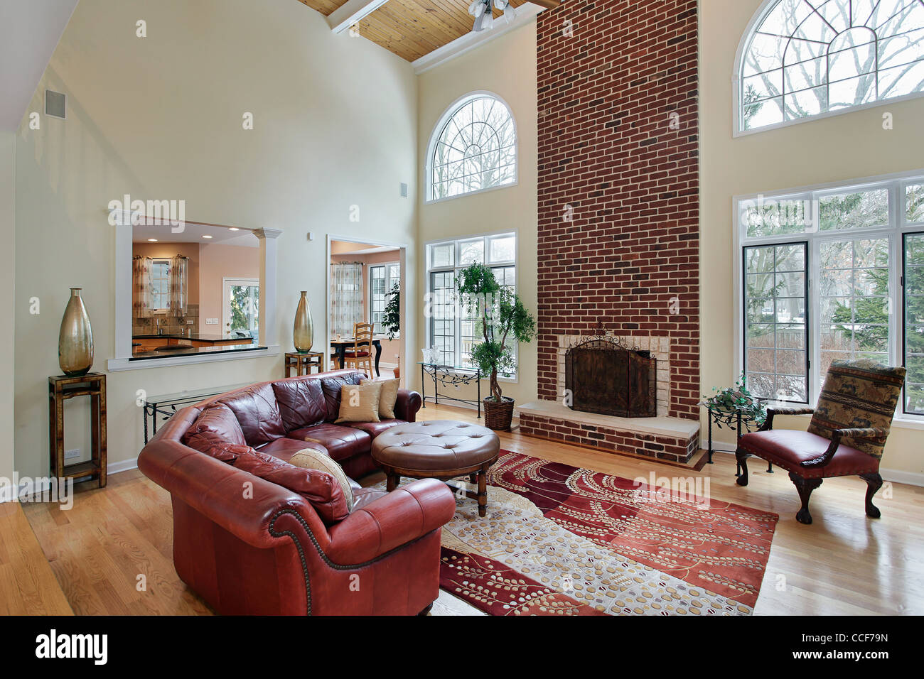 Family room in suburban home with two story brick fireplace Stock Photo