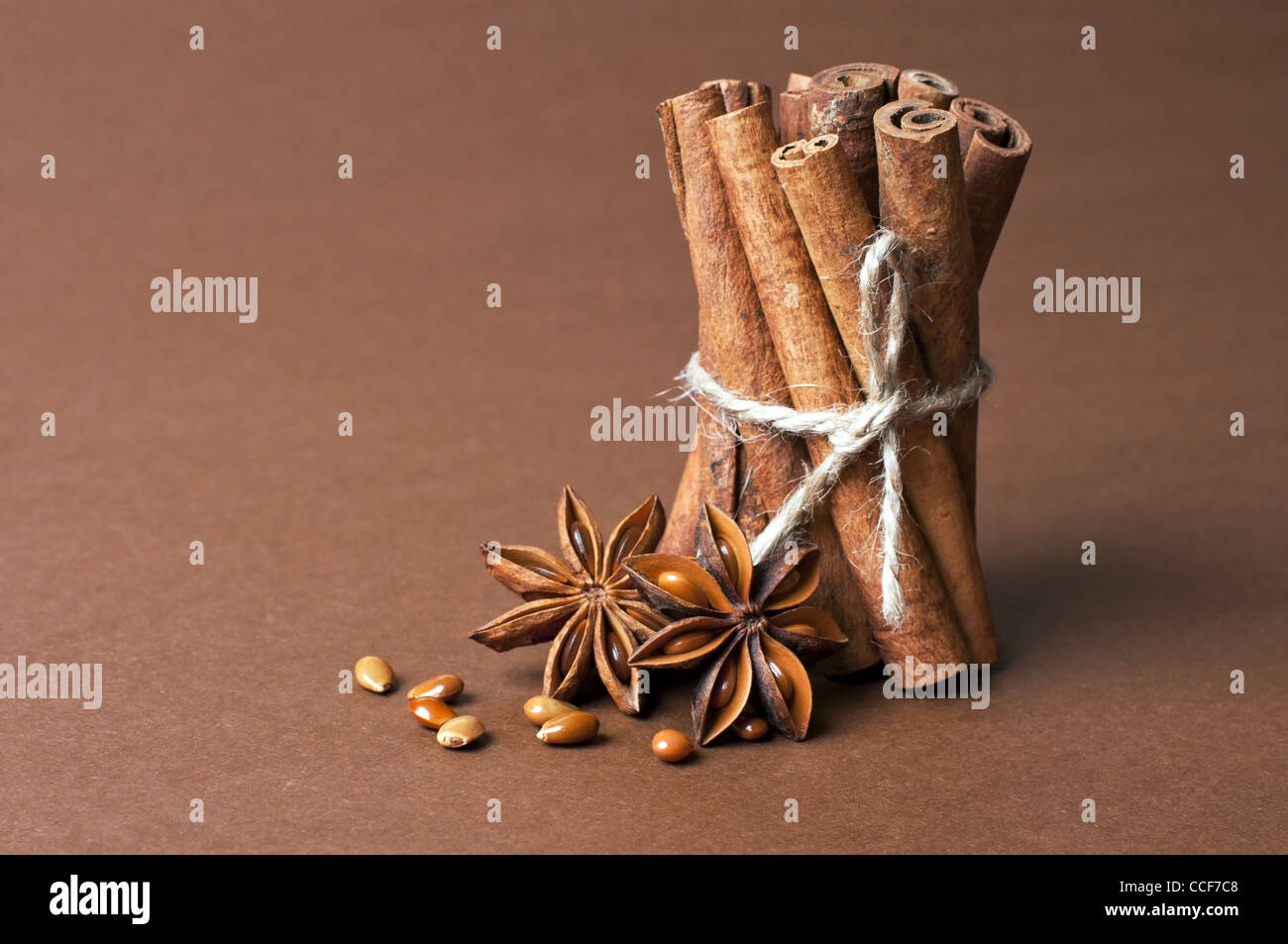 Cinnamon stick and anise stars on brown background Stock Photo