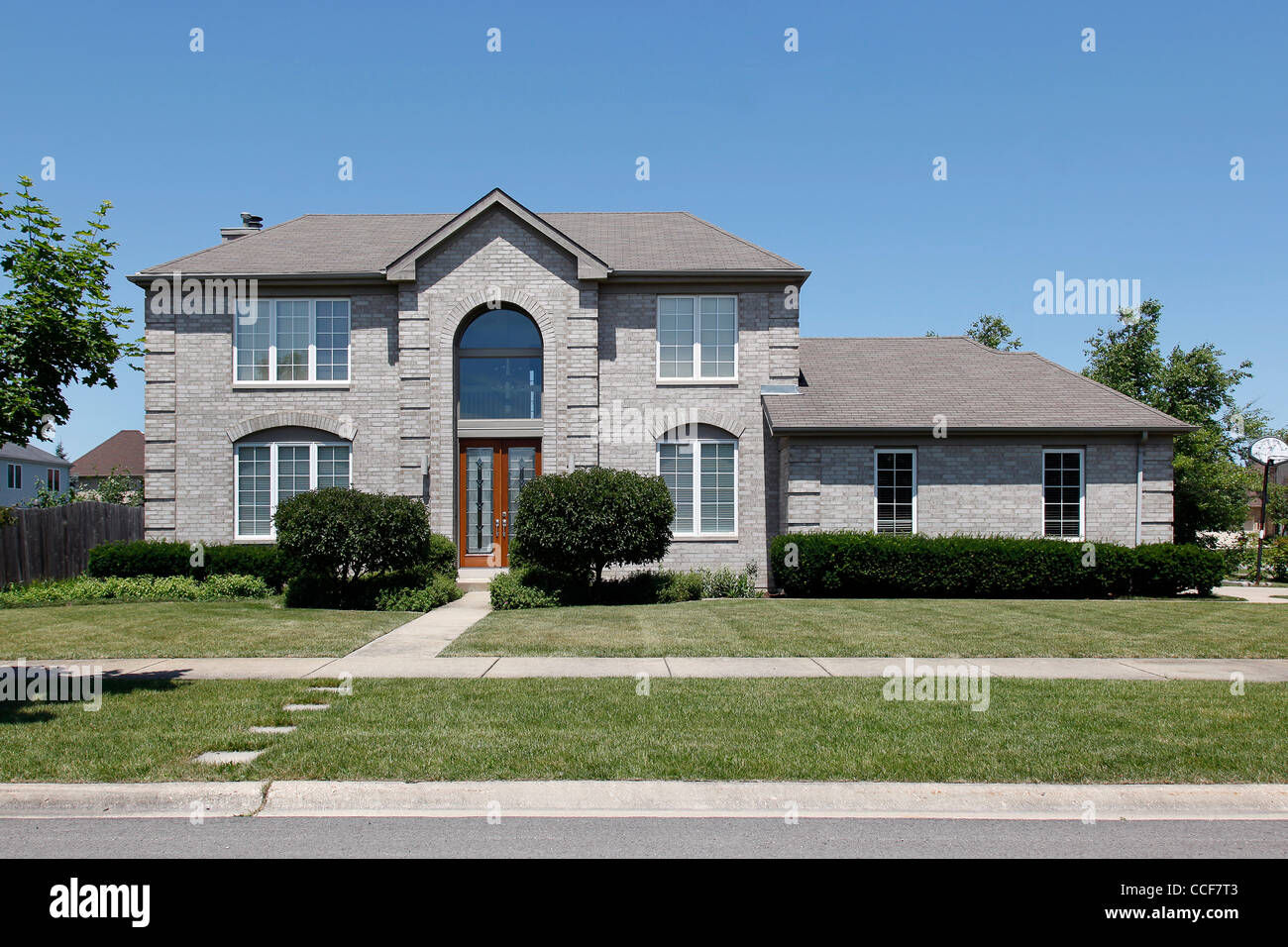 Gray brick home with glass front door Stock Photo