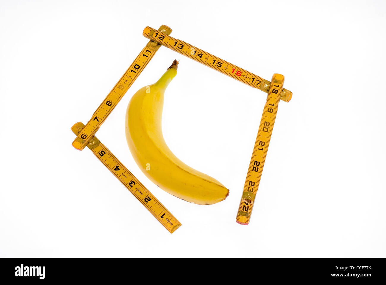 This banana is getting measured with a ruler Stock Photo