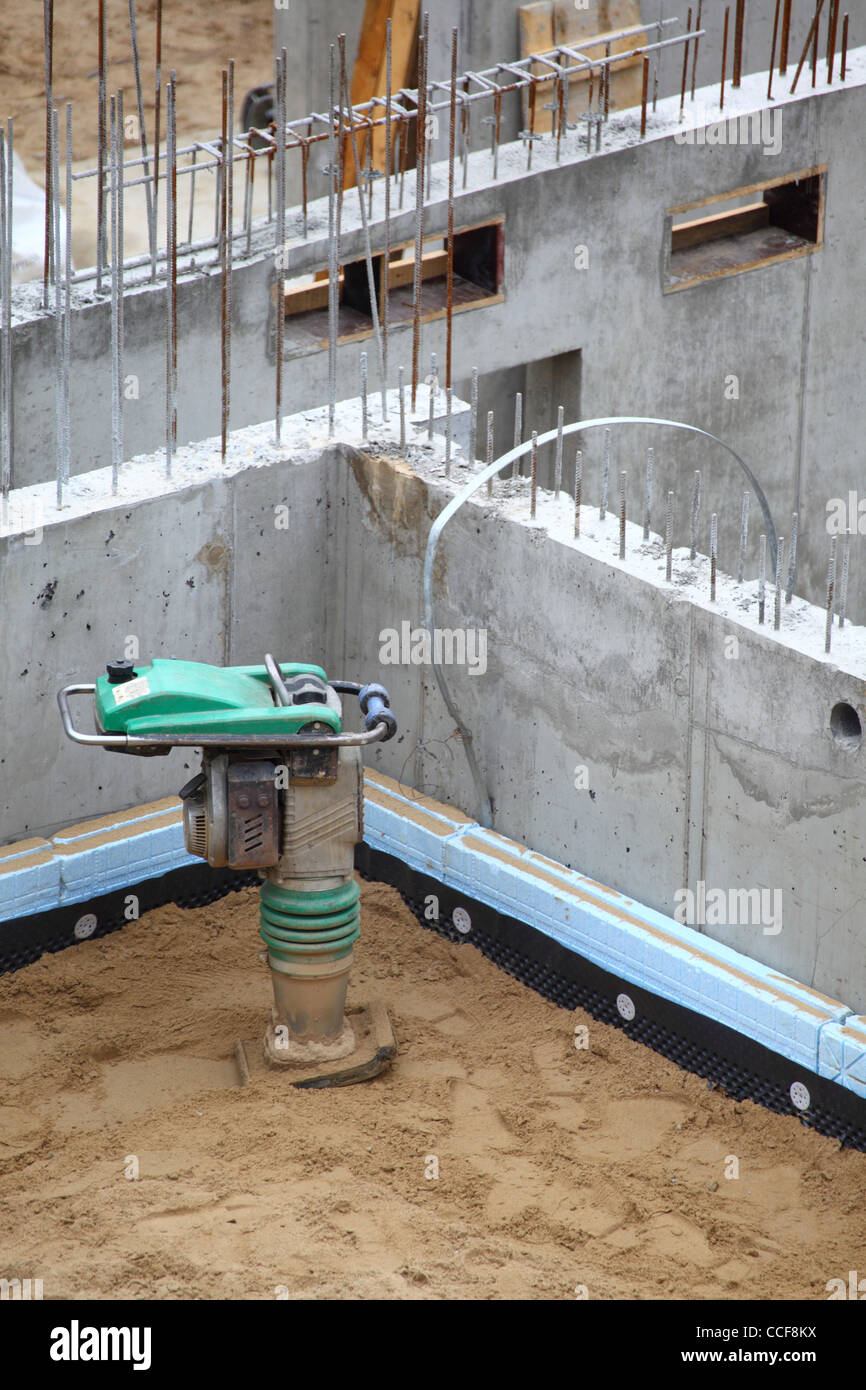 site working with compress tool - sand Stock Photo