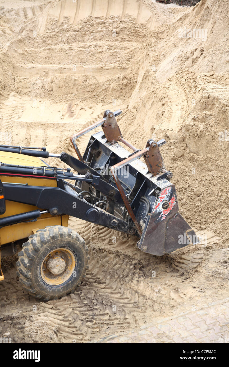 Yellow excavator on the construction site Stock Photo - Alamy