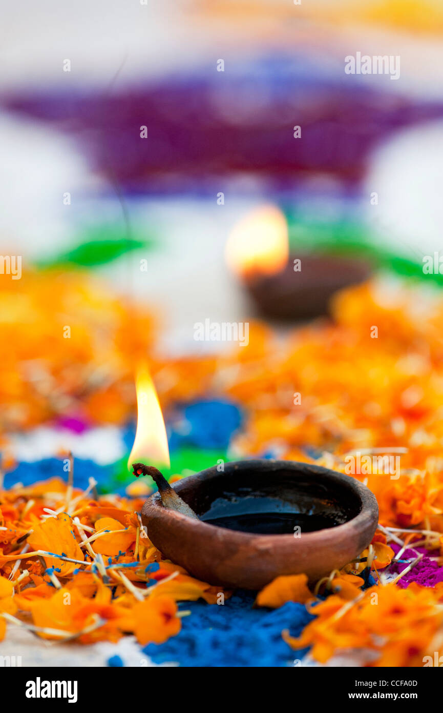 Burning oil lamps on a festival Rangoli design. Puttaparthi, Andhra Pradesh, India Stock Photo