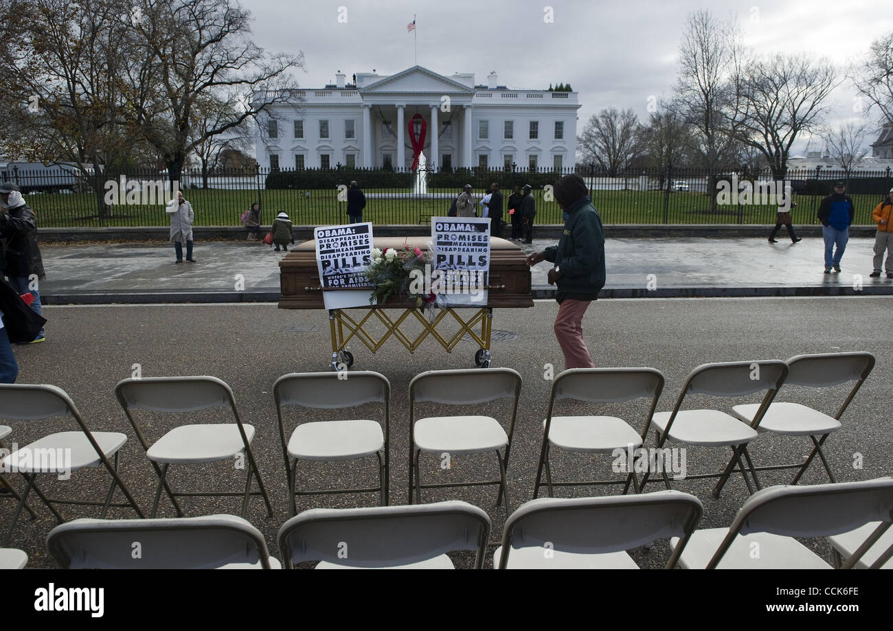 A man stands near a casket in front of the White House to bring awareness of the worldwide AIDS epidemic  to the Obama administration, in Washington, D.C., December 1, 2010. Photograph ©Mannie Garcia Stock Photo