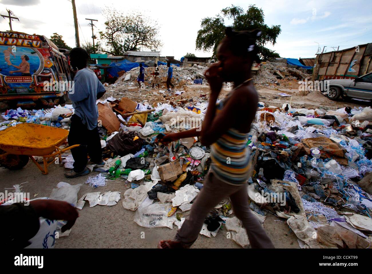 Nov. 10, 2010 - Port-au-Prince, Haiti - Residents walk by large piles ...
