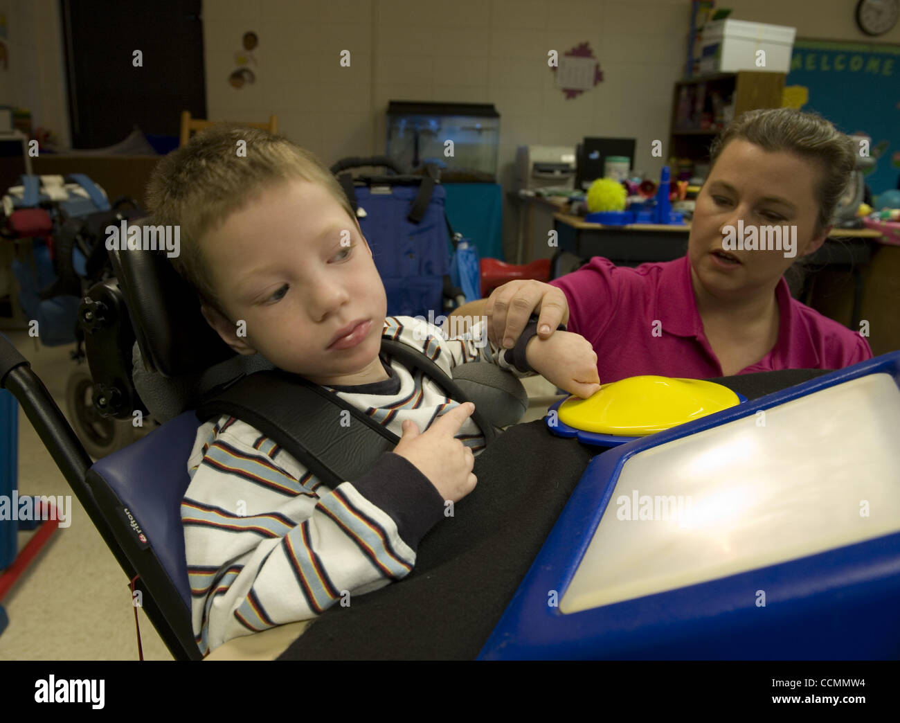 Oct. 28, 2010 - Woodstock, GA, USA - Bascomb Elementary School special education teacher comforts student in Severe and Profound disability classroom. He has cerebral palsy, a seizure disorder and sensory integration disorder (SID)  a neurological disorder that results from the brain's inability to  Stock Photo