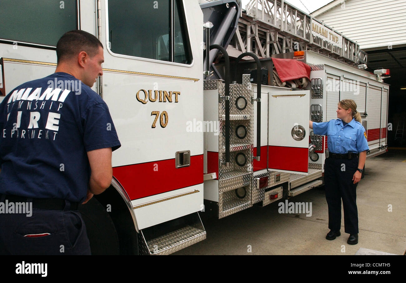 Jun 25, 2004 - Miami Township, Ohio, USA - Miami Township Firefighters STEVE WHITAKER (L) and AMY GEMMELL (R) operate the 75 ft. aerial ladder truck  that is dispatched from the township's Shady Lane fire station.  The Shady Lane station is one of four that serves the township.  (Credit Image: © Ken Stock Photo