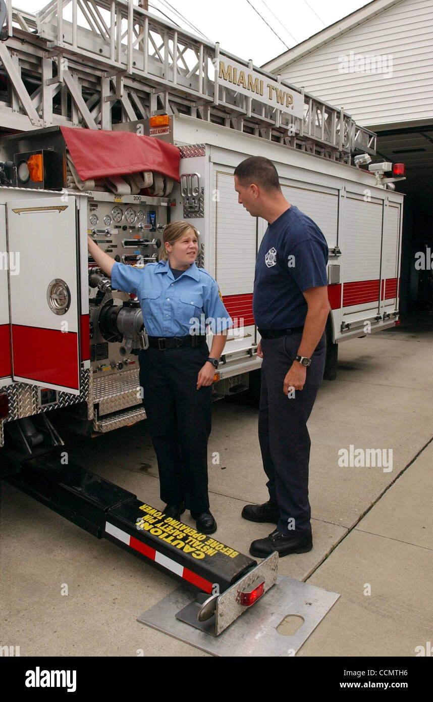 Jun 25, 2004 - Miami Township, Ohio, USA - Miami Township Firefighters STEVE WHITAKER (R) and AMY GEMMELL (L) operate the 75 ft. aerial ladder truck  that is dispatched from the township's Shady Lane fire station.  The Shady Lane station is one of four that serves the township. (Credit Image: © Ken  Stock Photo