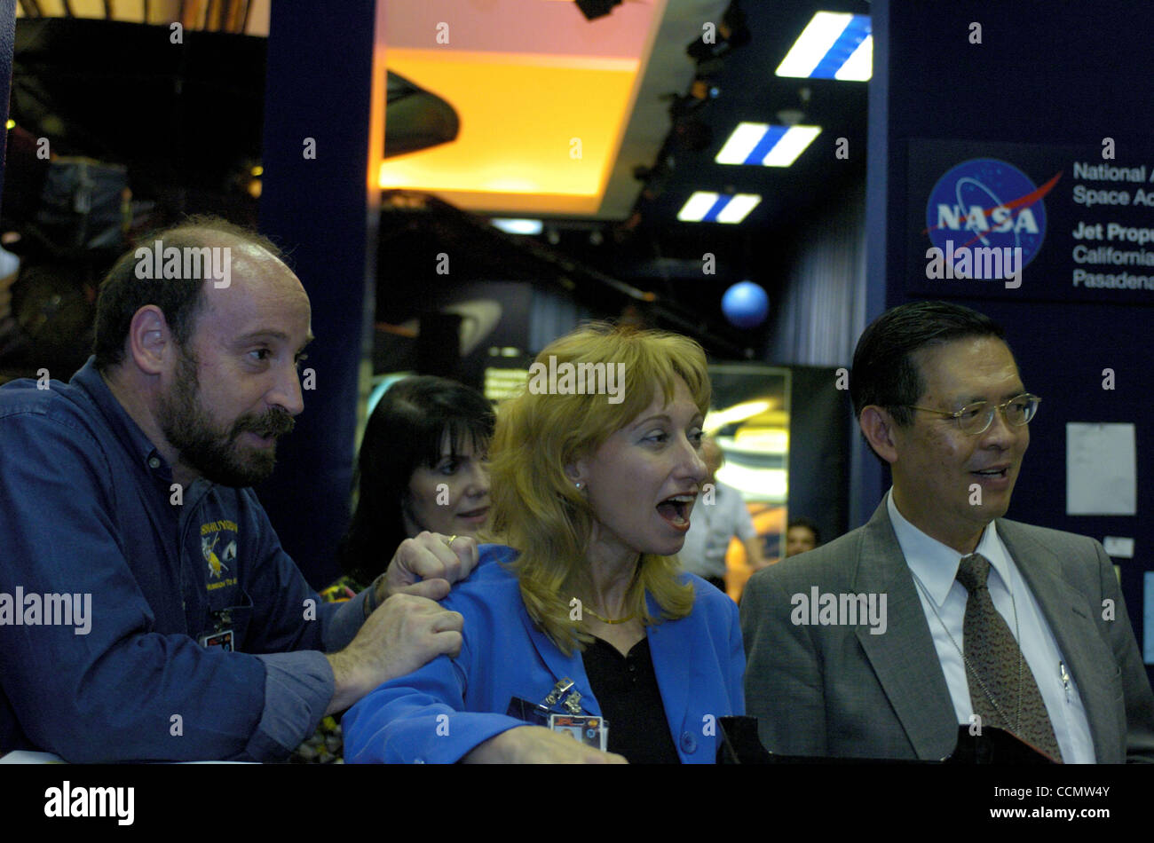 (L-R) Dr. Randii R. Wesson (Navigator Program Engineer), Dr. Rosaly M.C. Lopes (research scientist), and Dr. Peter T. Poon (telecommunications & system mgr.) all watch in anticipation of Cassini's successful navigation at 53,000 mph pthrough the rings of Saturn. 6/30/04, Pasadena, Ca, Rob DeLorenzo Stock Photo