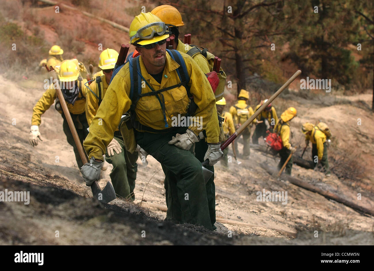 Jul 16, 2004; Carson City, CA, USA; Bureau of Indian Affairs firefighter DAVE CURNS leads a squad of his peers on a search for hotspots Friday, July 16, 2004 in the Lakeview Estates area of Carson City, Nevada. Hilly terrain, whipping winds and erratic fire behavior continued to challenge crews batt Stock Photo