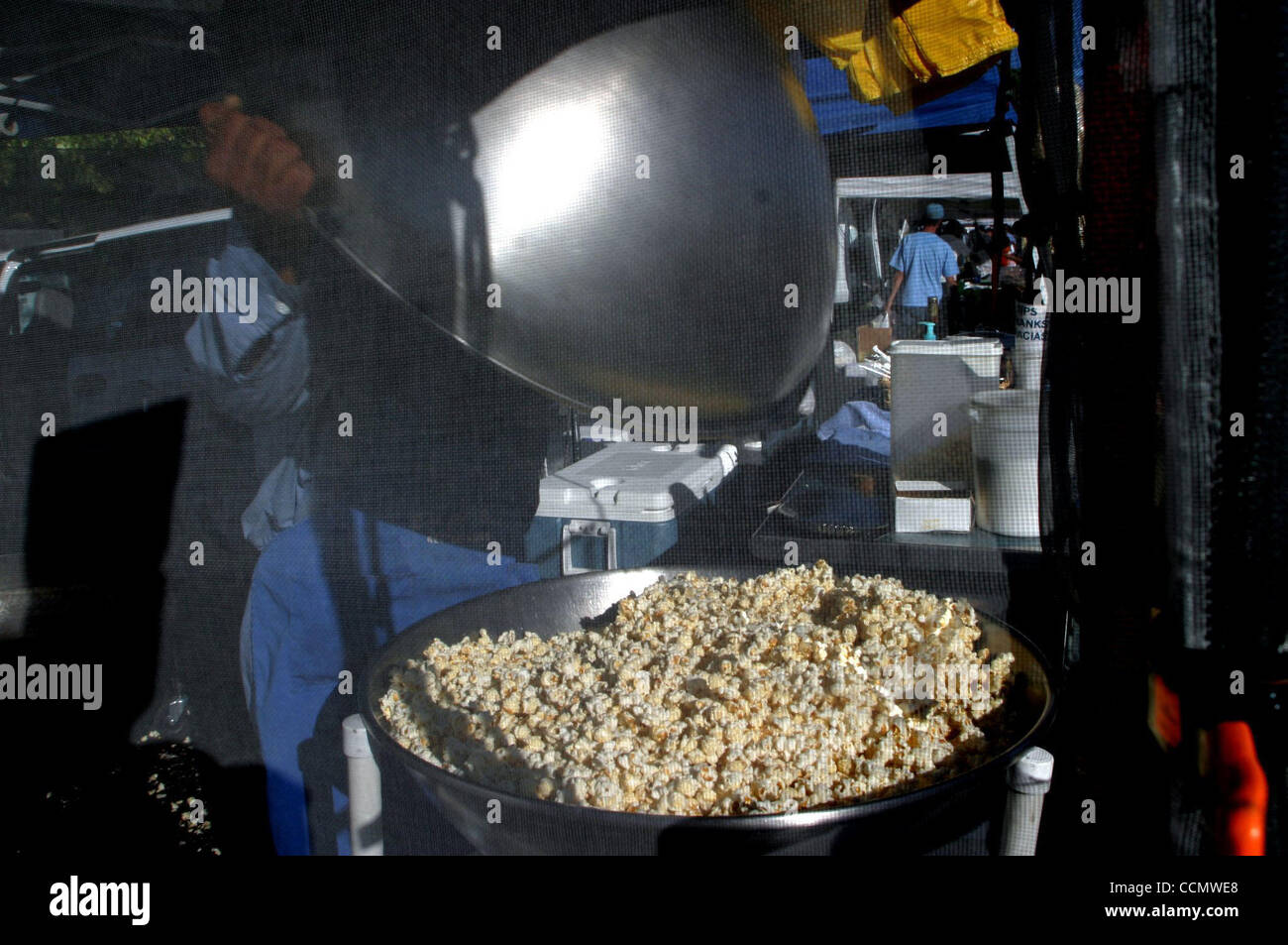 Fernando Ontiberos (cq) fills a tub with fresh Kettle Corn during the first Brentwood Farmers
