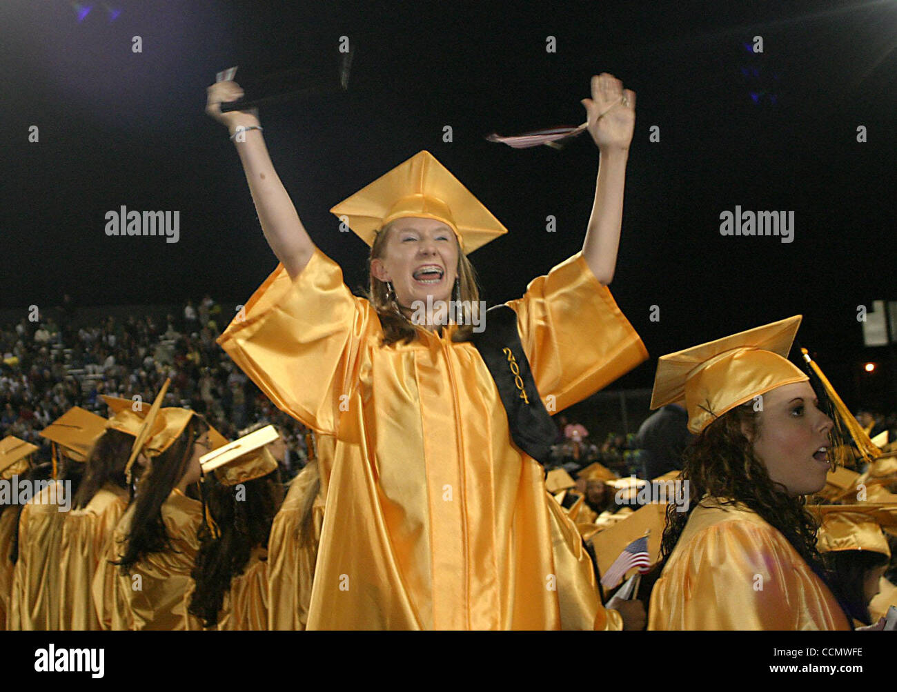 Dawn Shoemaker (cq) throws her arms in the air during graduation