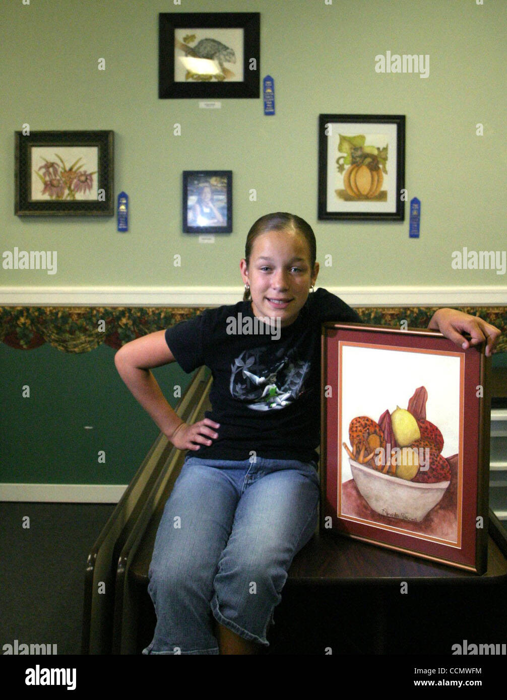 Amanda Russell (cq), 11 yearsold, sits with her painting "Ms. Amity's