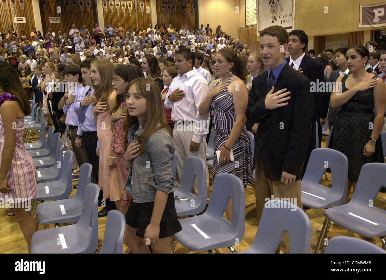 The Piedmont Middle School class of 2004 recite the Pledge of Allegiance at the start of their graduation ceremony at the Piedmont High School gym in Piedmont, Calif., on Monday, June 14, 2004. (CONTRA COSTA TIMES/EDDIE LEDESMA) Stock Photo