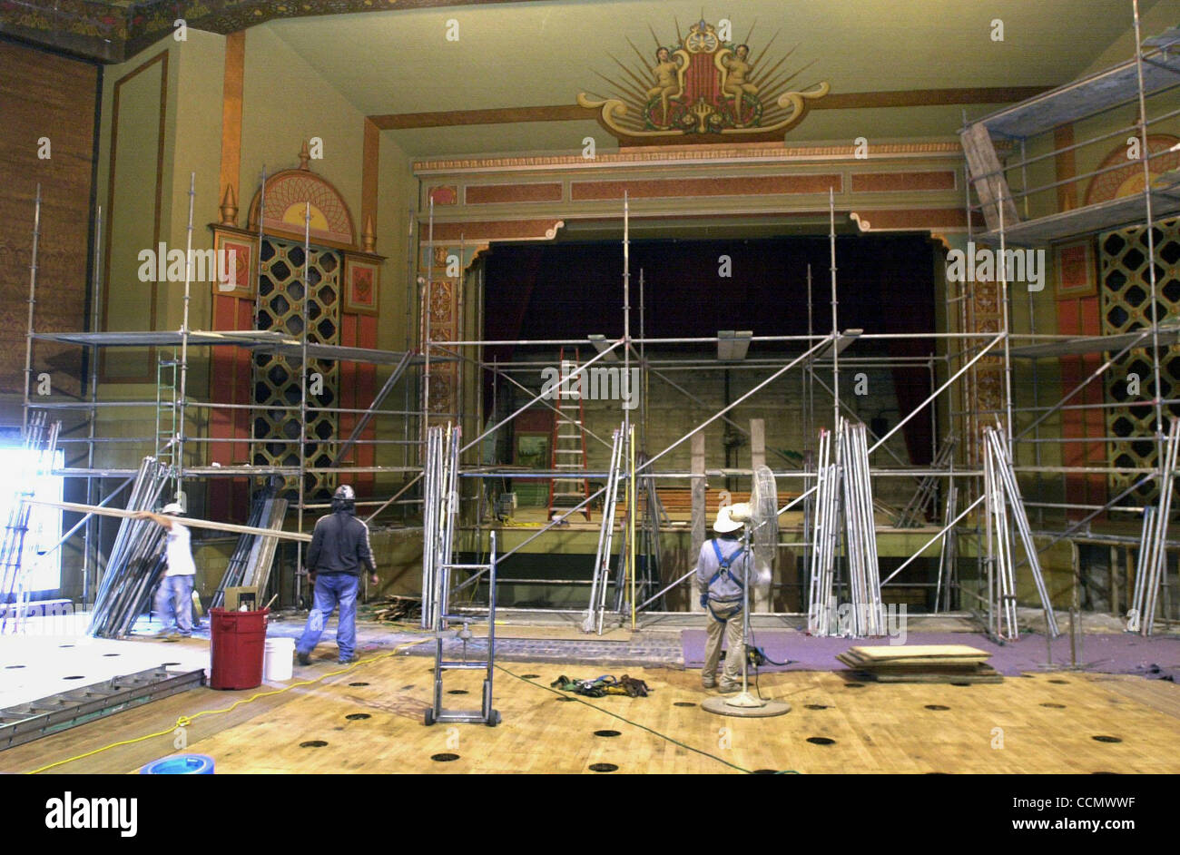ON THE FRONT---John Sauter, left, Ken Pharris and Rudy Reyes remove the scaffolding after the repainting of the interior of the El Campanil Theatre an ornate 1920's art deco theater in downtown Antioch California on Friday, April 23, 2004.  (Contra Costa Times/HERMAN BUSTAMANTE JR.) Stock Photo