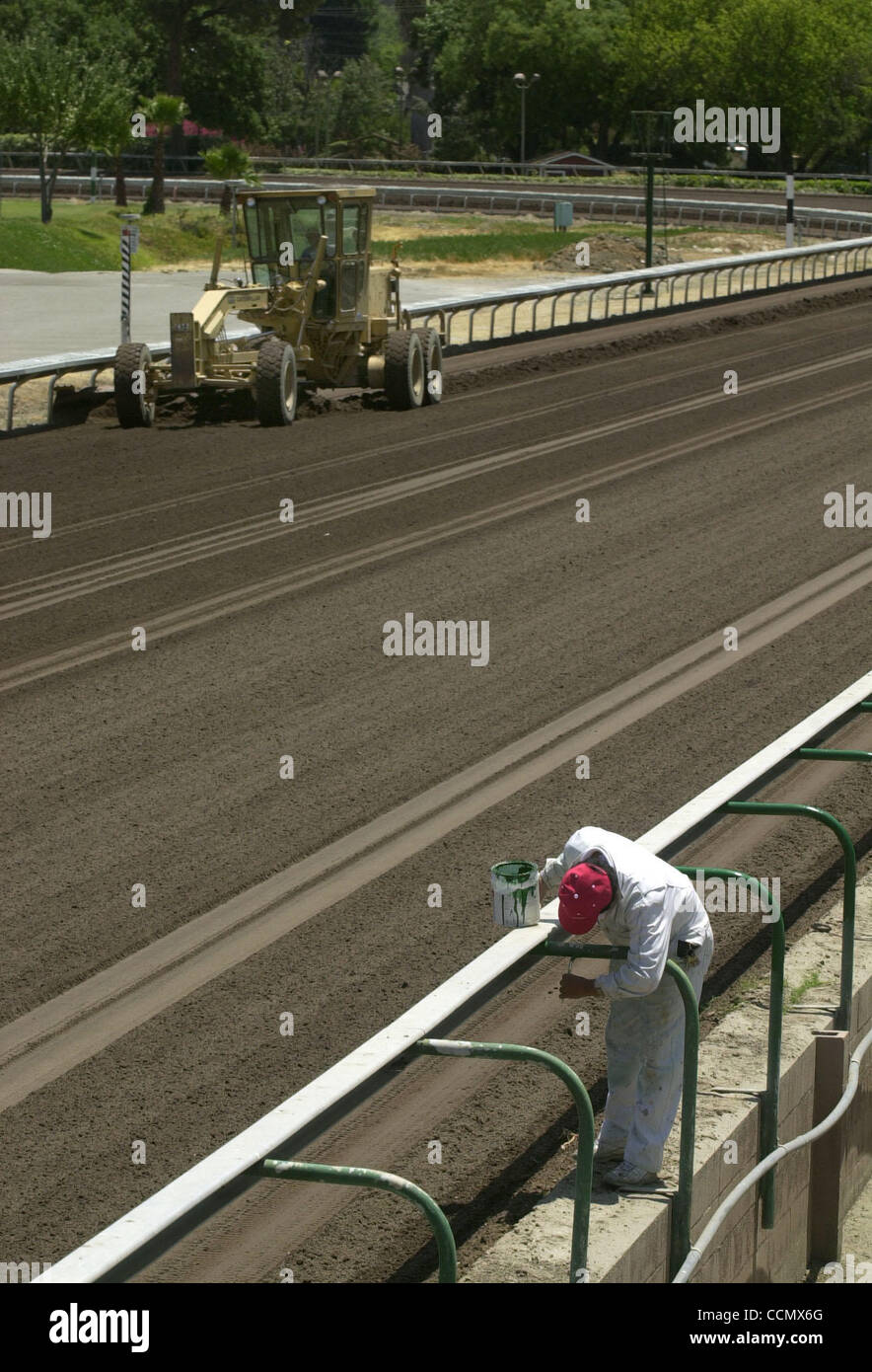Forest green 'the same color as money' says painter Noel Rodriguez of Modesto who touches up the railing at the horse race track at the Alameda County Fair, Tuesday, June 29, 2004, in Pleasanton, Calif where the track is being groomed in preparation of horse racing Wednesday. (Contra Costa Times/Sus Stock Photo