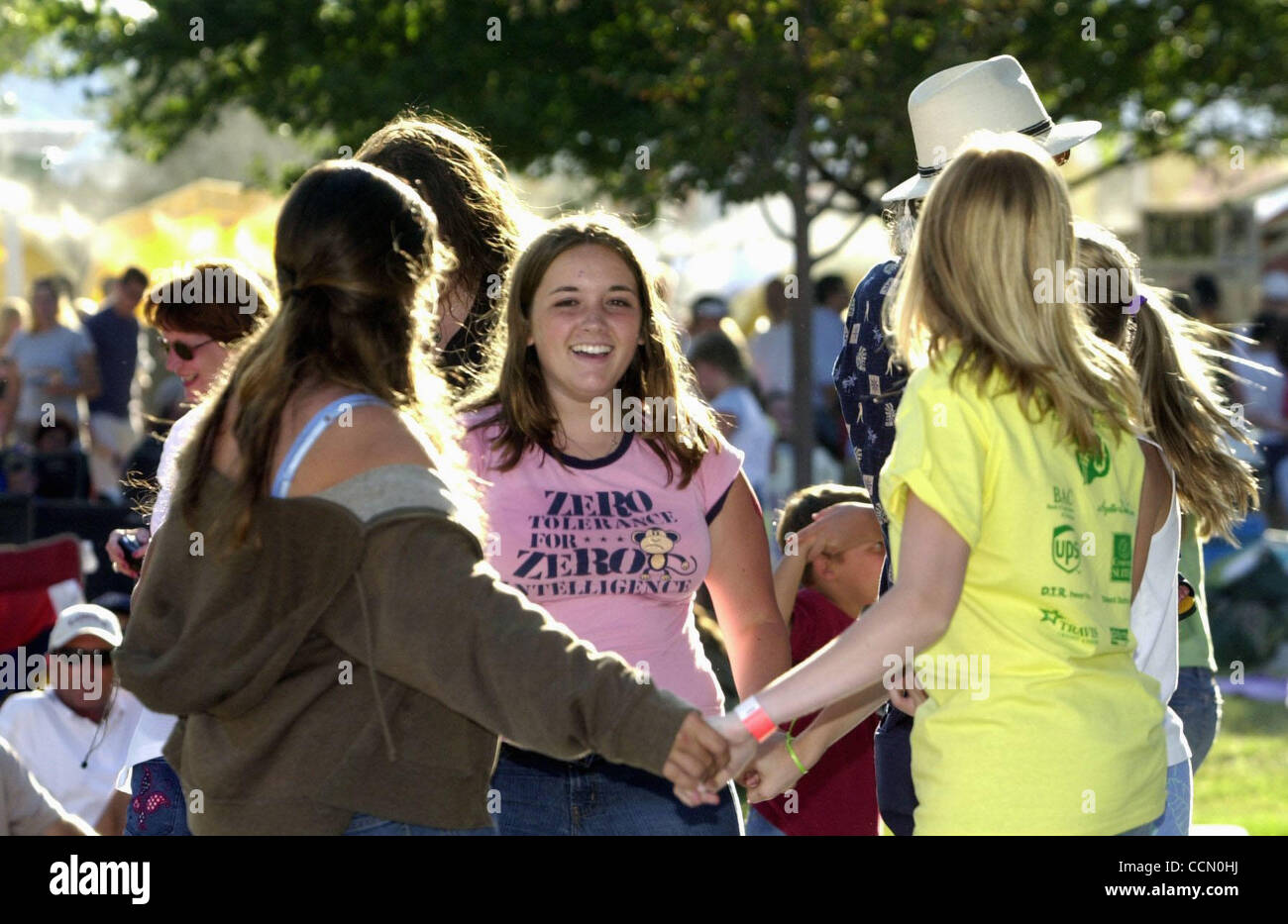 (center) Jennifer Haffen (cq), 16, of Brentwood dances with friends as Peter Tork  - Shoe Suede Blues perform on the park stage at the 12th Anniversary CornFest in Brentwood, Calif., on Saturday, July 10, 2004. In addition to the live music the 3 day event features carnival rides, games, and lots of Stock Photo