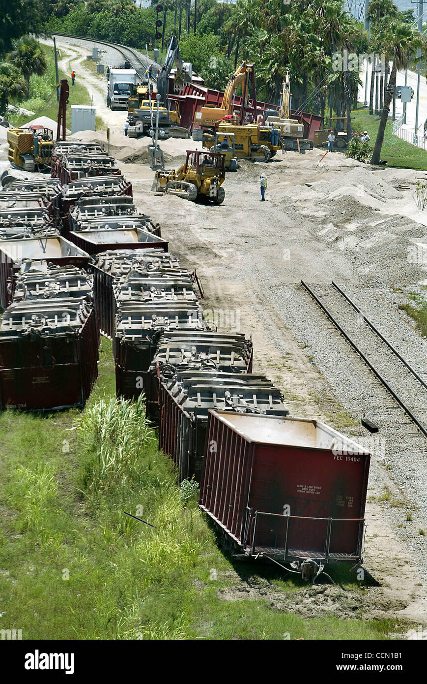 072504StuartDerailment service workers clean up after 31 cars of a
