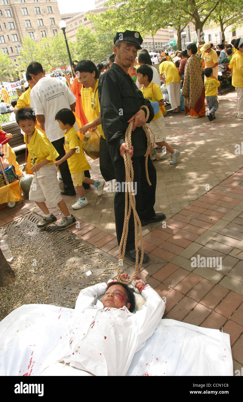 Jul 25, 2004; Boston, Ma, USA; Falun Gong practitioners bring awareness to the persecution & torture they face in China. A practitioner (L) plays the role of victim  & the other (R) Chinese Communist killer in Copley Square. Stock Photo
