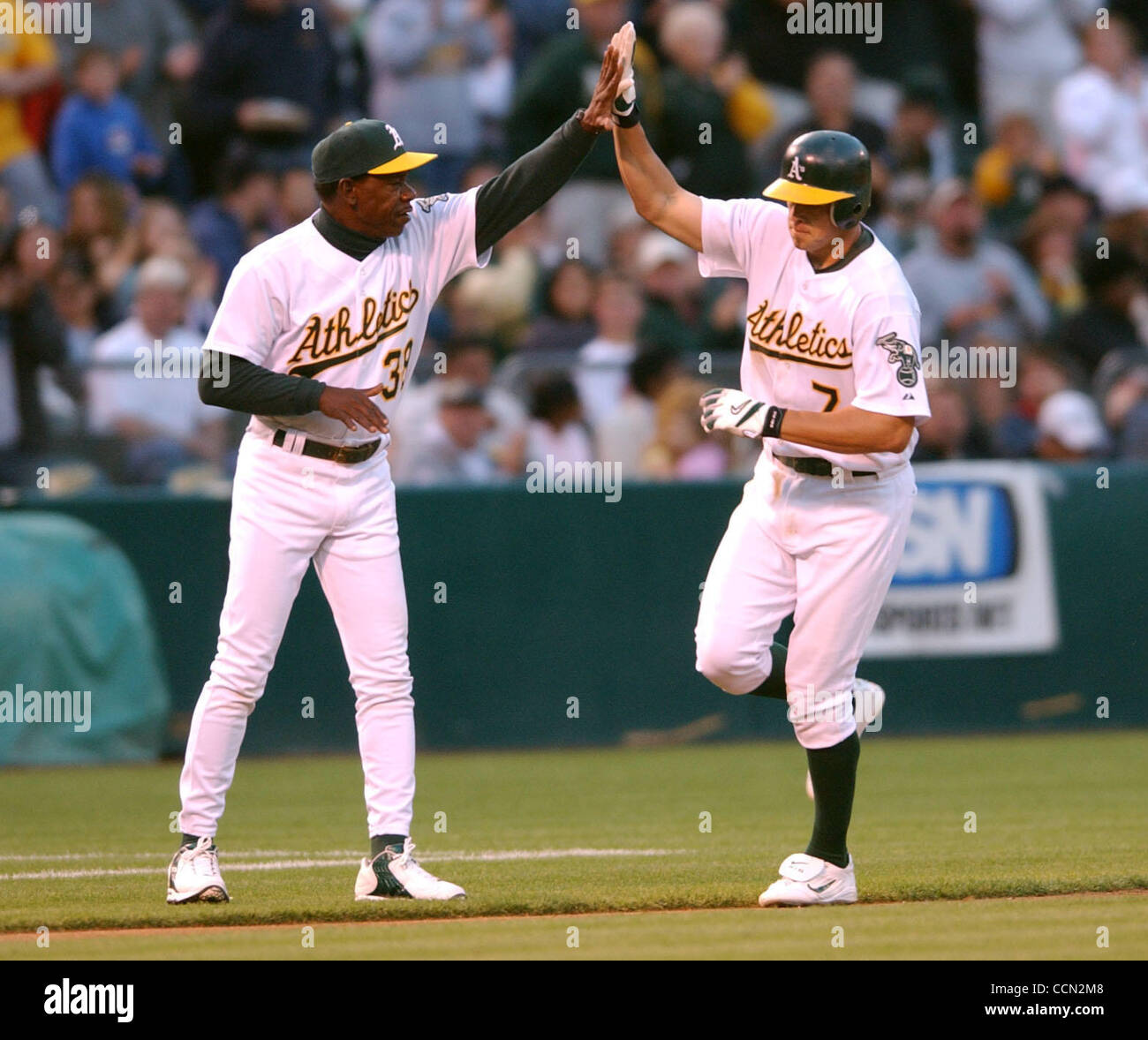 Oakland Athletics Bobby Crosby gives a high five to 3rd base coach Ron Washington in the 4th