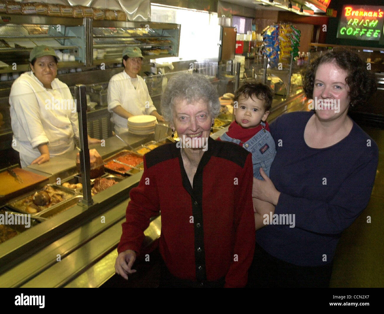 Brennan's restaurant owner Elizabeth Wade, her grandson Sebastian Barboza, 16 months, and her daughter and Sebastian's mom Margaret Wade, stand next to the hof brau style serving counter of the restaurant in Berkeley, Calif., on Tuesday July 27, 2004. Brennan's was established in 1959 and is not goi Stock Photo