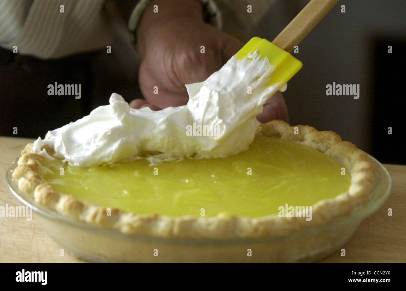 Wilbur Wong Applies The Meringue To His Lemon Pie For The