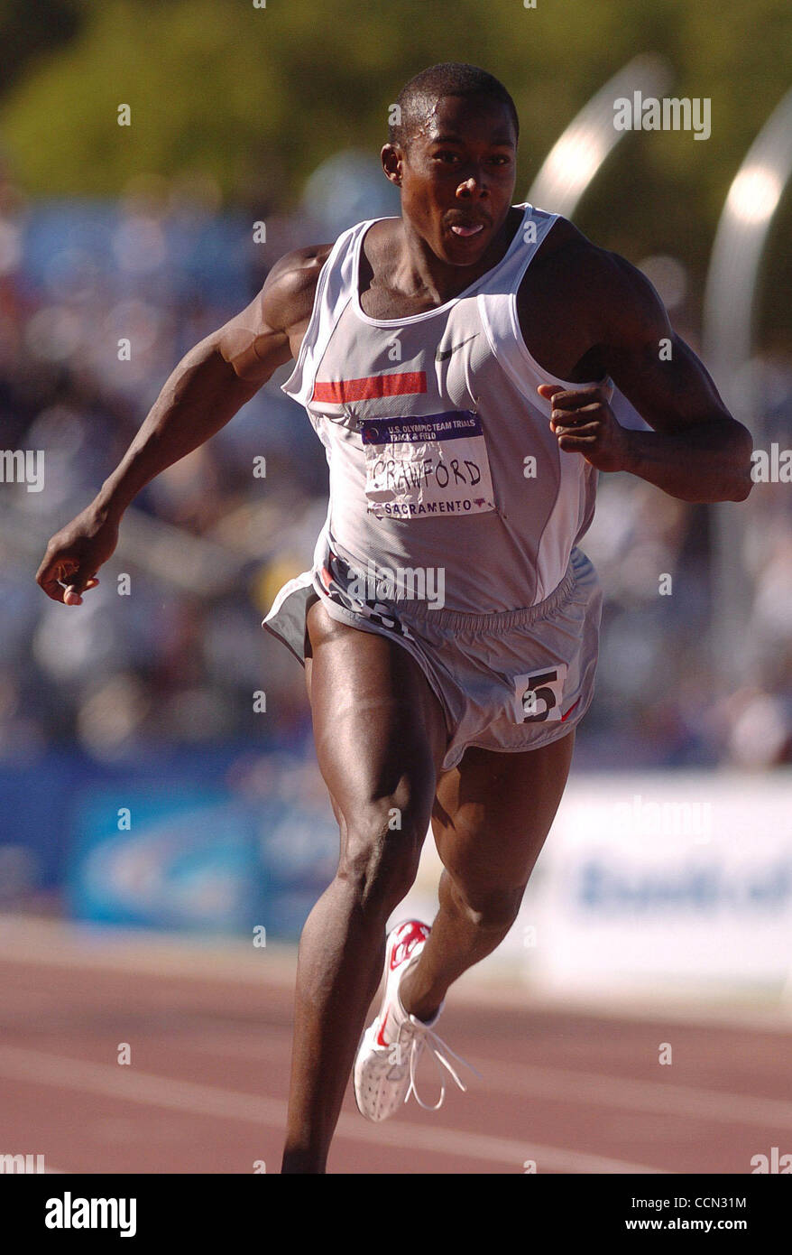 Shawn Crawford places first with a time of 19.99 seconds in the Men's