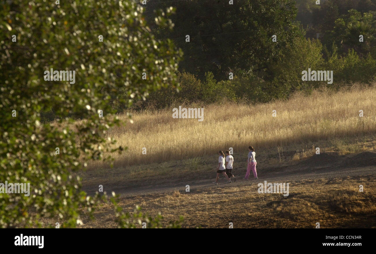 7:34 am: Early morning hikers walk through the Lime Ridge Open Space in ...