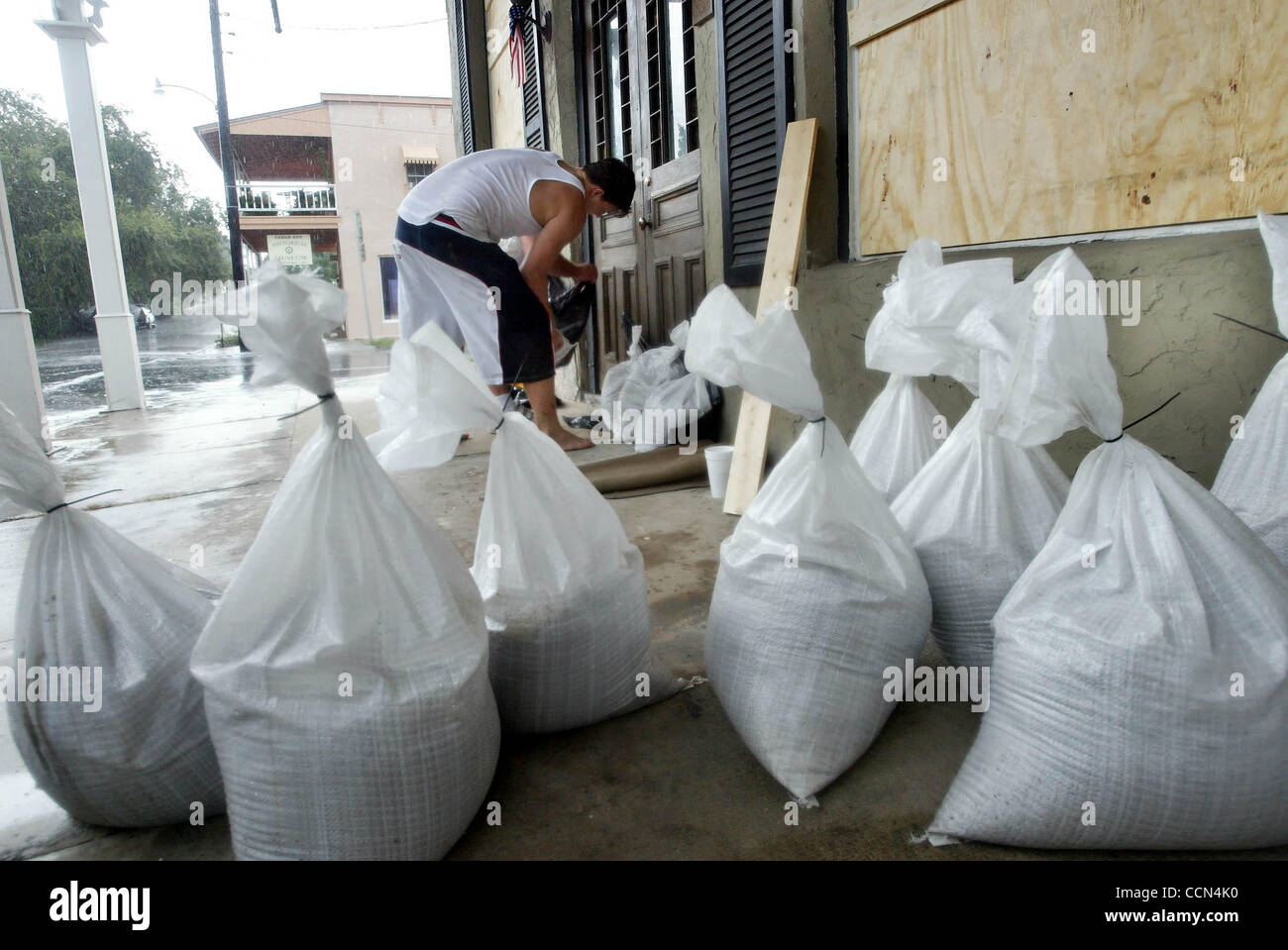 CEDAR KEY; 8/13/04:  Tommy Smart, Jr.  (cq) stacks sandbags in the doorway of  his parents' restaurant, T & S Seafood ,   to protect against flooding Friday afternoon.  Cedar Key  residents filled sandbags and delivered them to homes and businesses in the lowest areas of the small Gulf-front communi Stock Photo