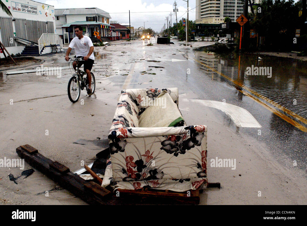 081304 met charleyafter6/9--Fort Myers Beach-A man rides his bike down 