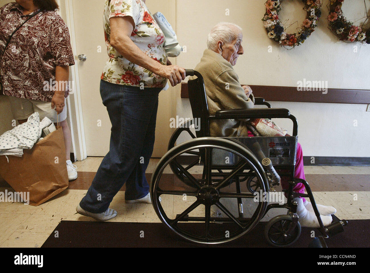 Nursing home:  The Desoto Health & Rehab Skilled Nursing Facility:   This nursing home suffered major damage:  all the residents were being moved out.  The one gentleman in the wheelchair is Jose Gonzalez, 89.  Known as 'Poppi'.  He was being moved from the facility by his daughter Esther Coleman ba Stock Photo