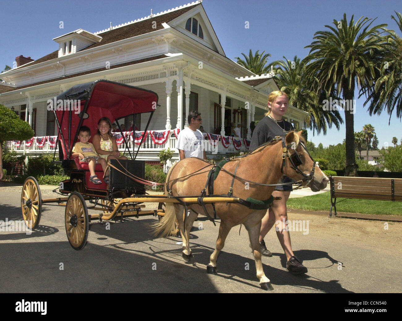 Eric Ruloma, 2, and his sister Briana Ruloma, 6, enjoy a ride in a ...