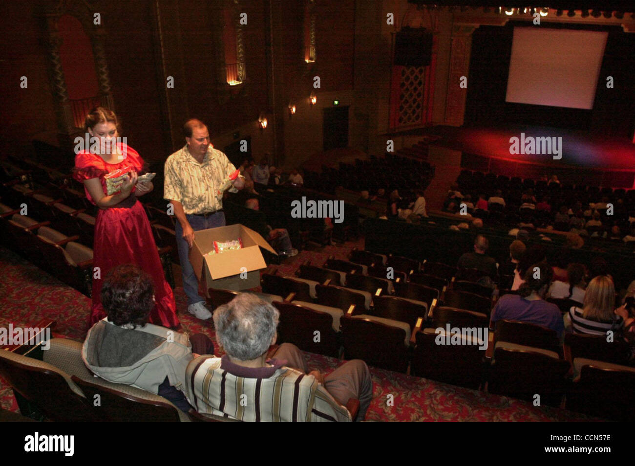 Esther Park an El Campanil Theatre board member dressed as Scarlett O'Hara sells popcorn with Andrew Johnson of Antioch, Calif., before the start of the movie 'Gone With the Wind' at the newly restored El Campanil Theatre in Antioch, Calif., on Friday, August 6, 2004. The historic El Campanil Theatr Stock Photo