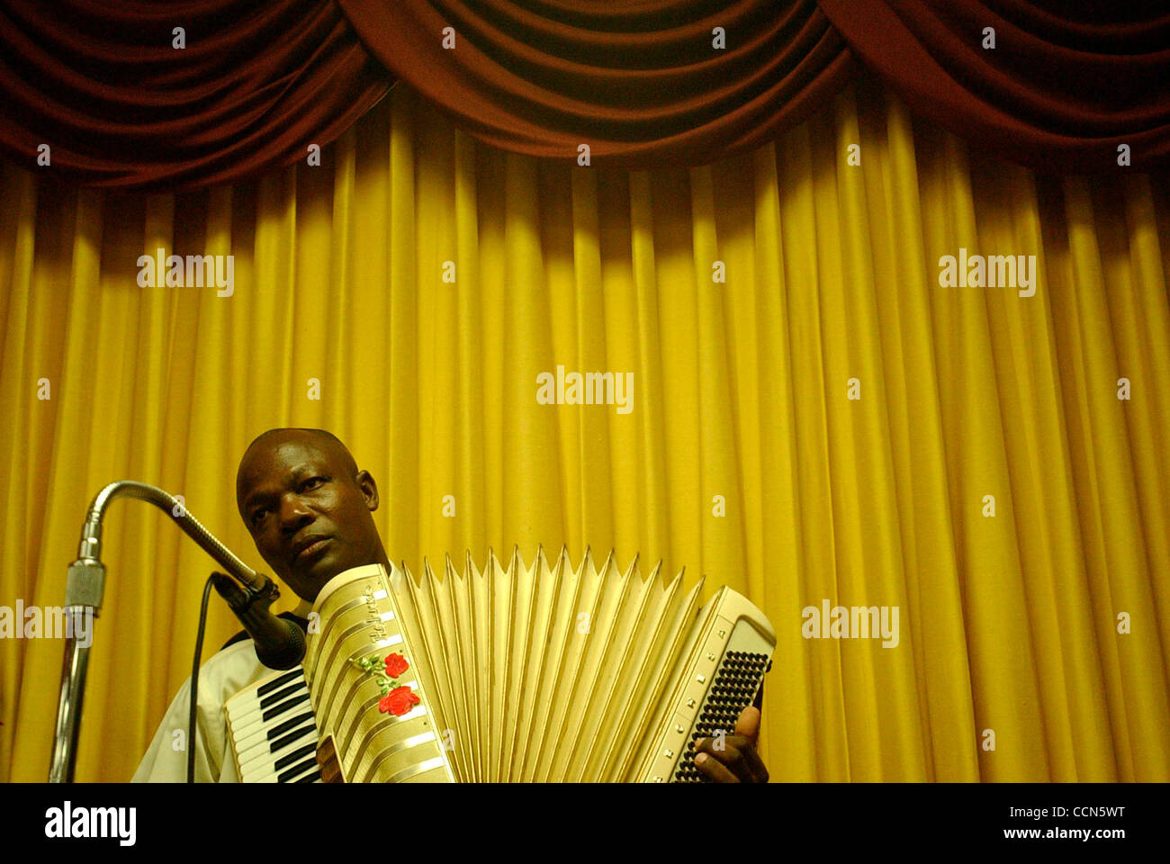 Aug 17, 2004; Miami, FL, USA; Haitian Jude Cesaire provides music as the congregation sings together during a revival service at the Haitian Baptist Church of the Living God in the Little Haiti neighborhood of Miami, FL on Tuesday, August 17, 2004. Stock Photo